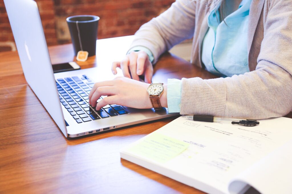 person using macbook on table